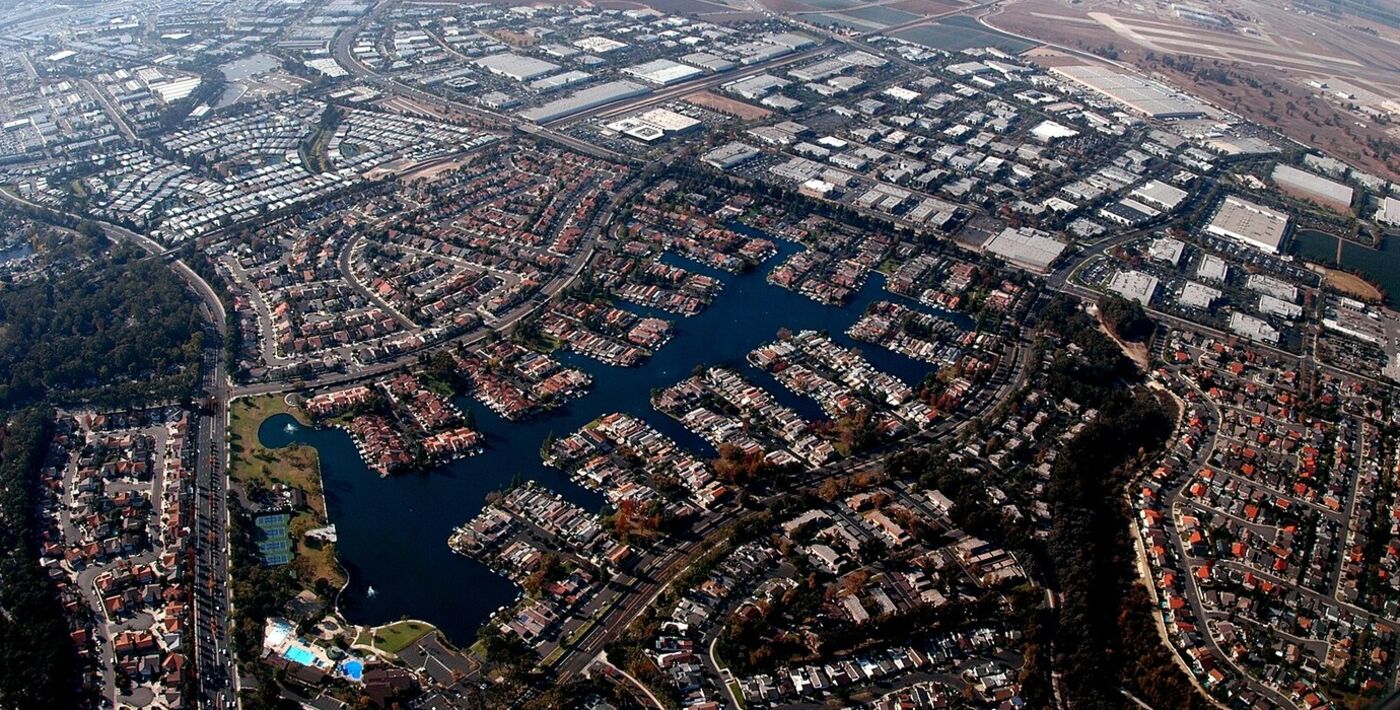 Aerial view of the Lake Forest II lake with homes built along its fingers and business parks beyond